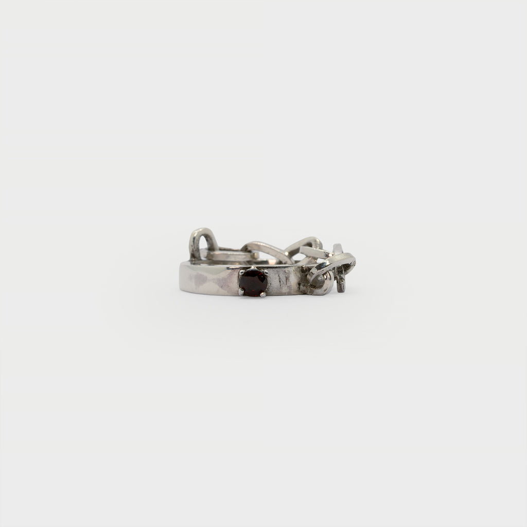 A found silver ring with a silver chain and a garnet.