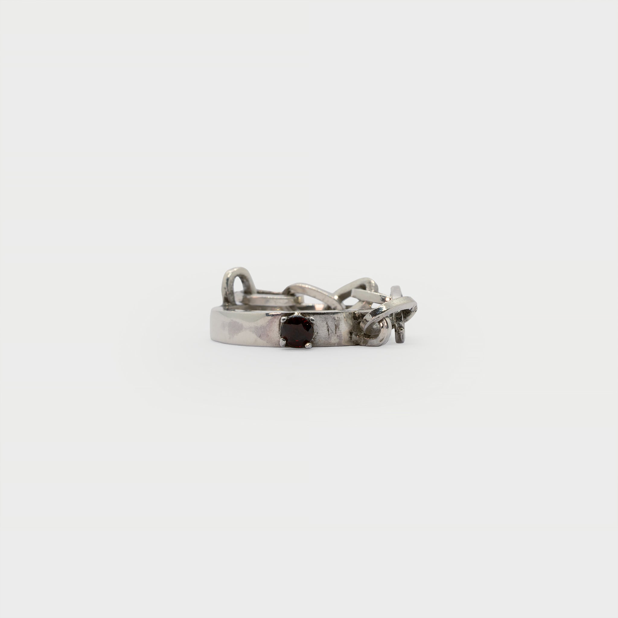 A found silver ring with a silver chain and a garnet.