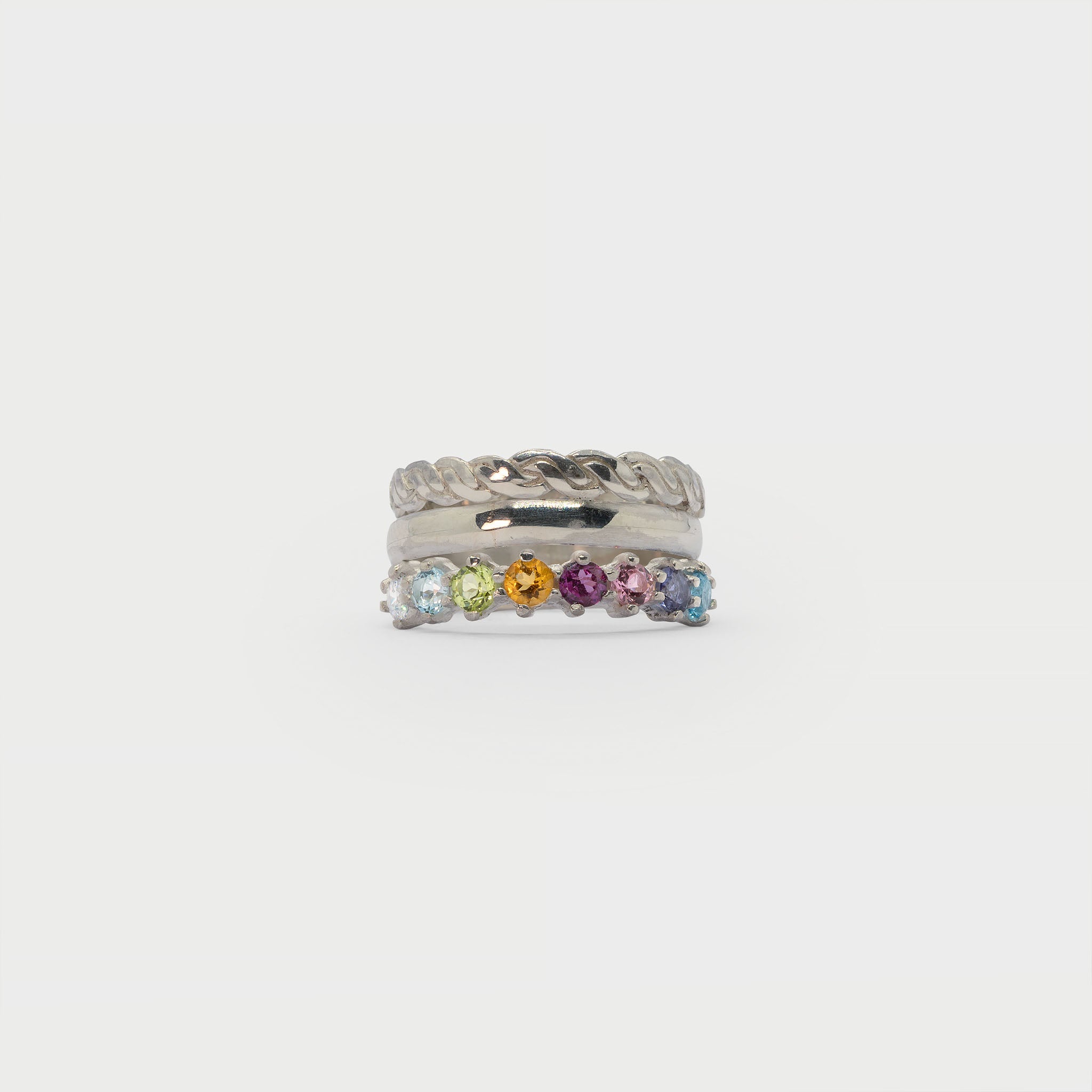 Two silver rings and a half eternity ring.