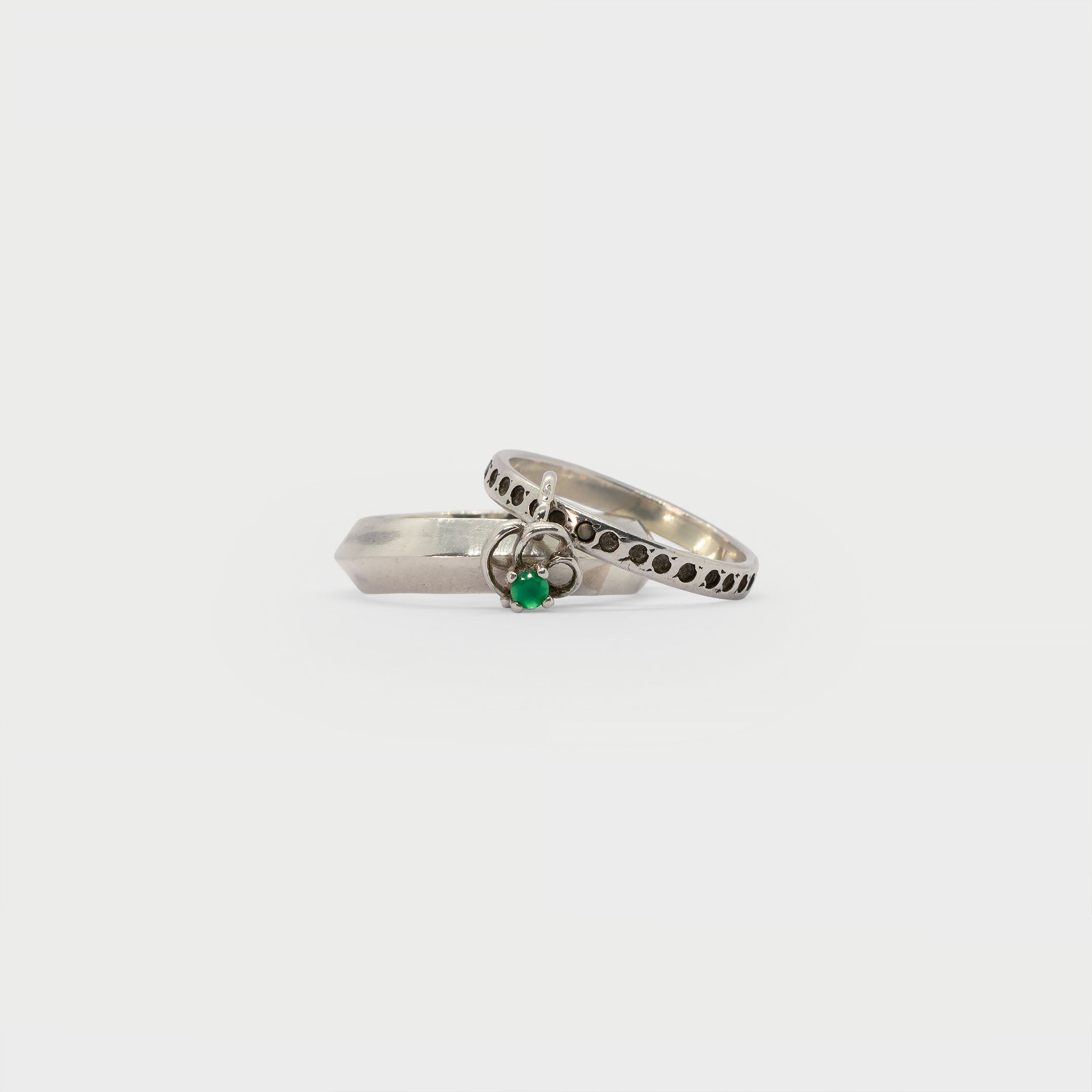 Two found silver rings and a single earring.
