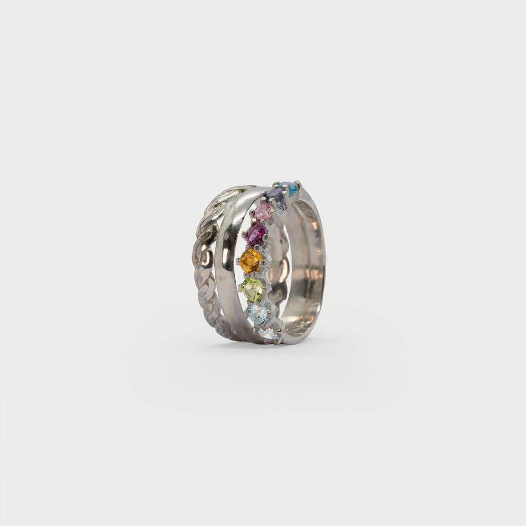 Two silver rings and a half eternity ring.