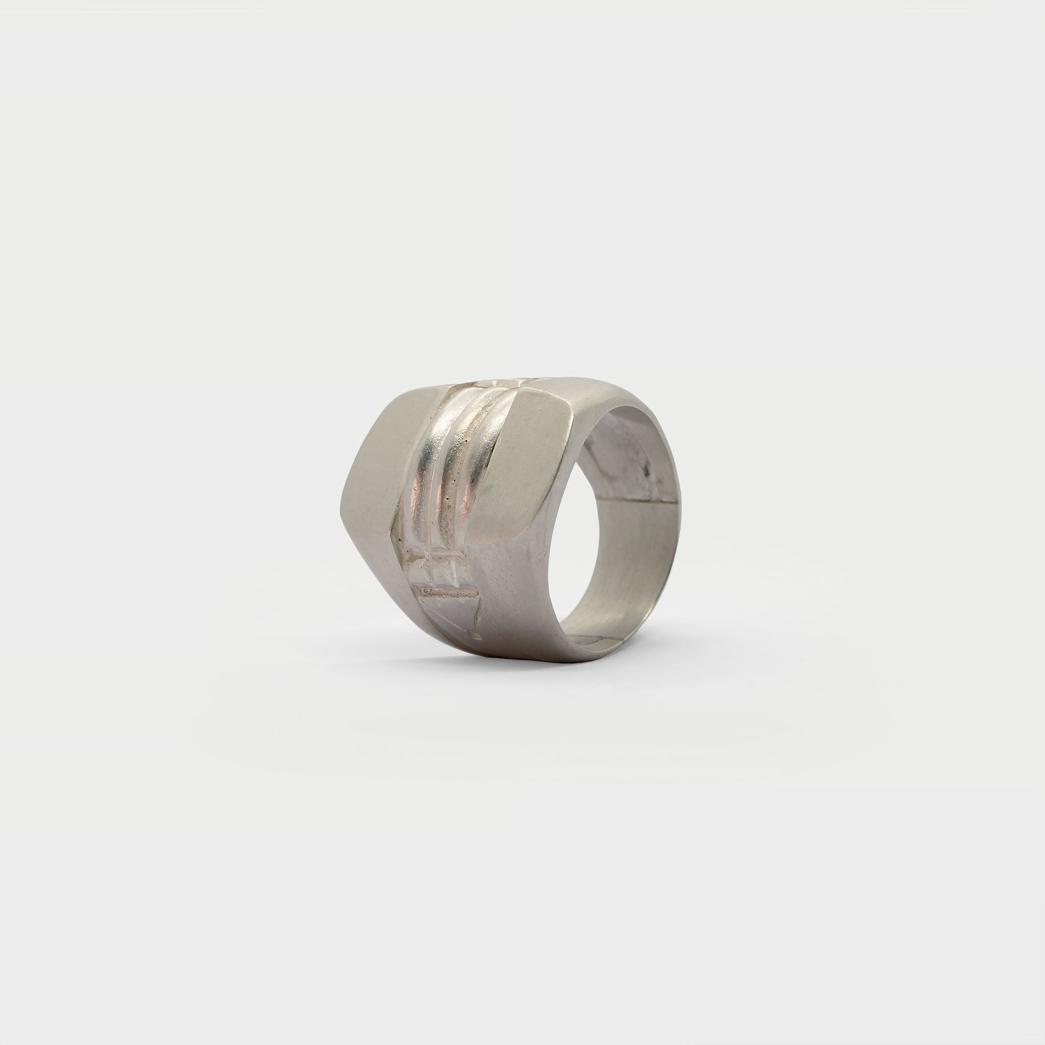 A pair of half signet rings and an engraved ring.