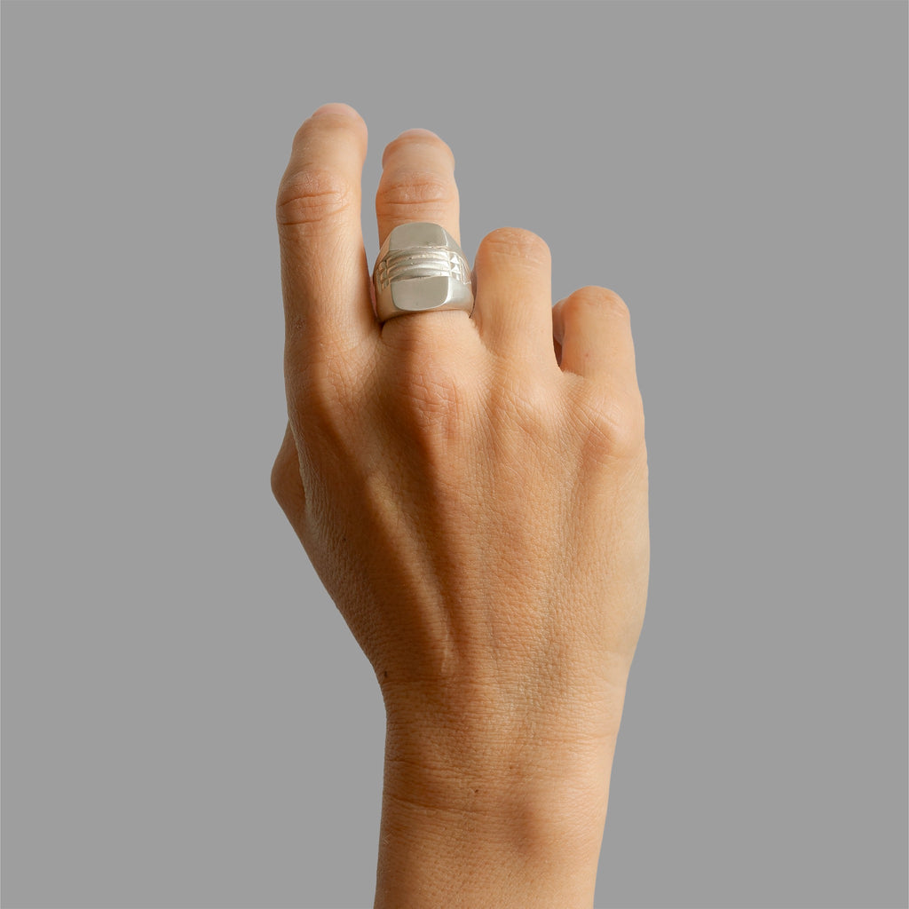 A pair of half signet rings and an engraved ring.
