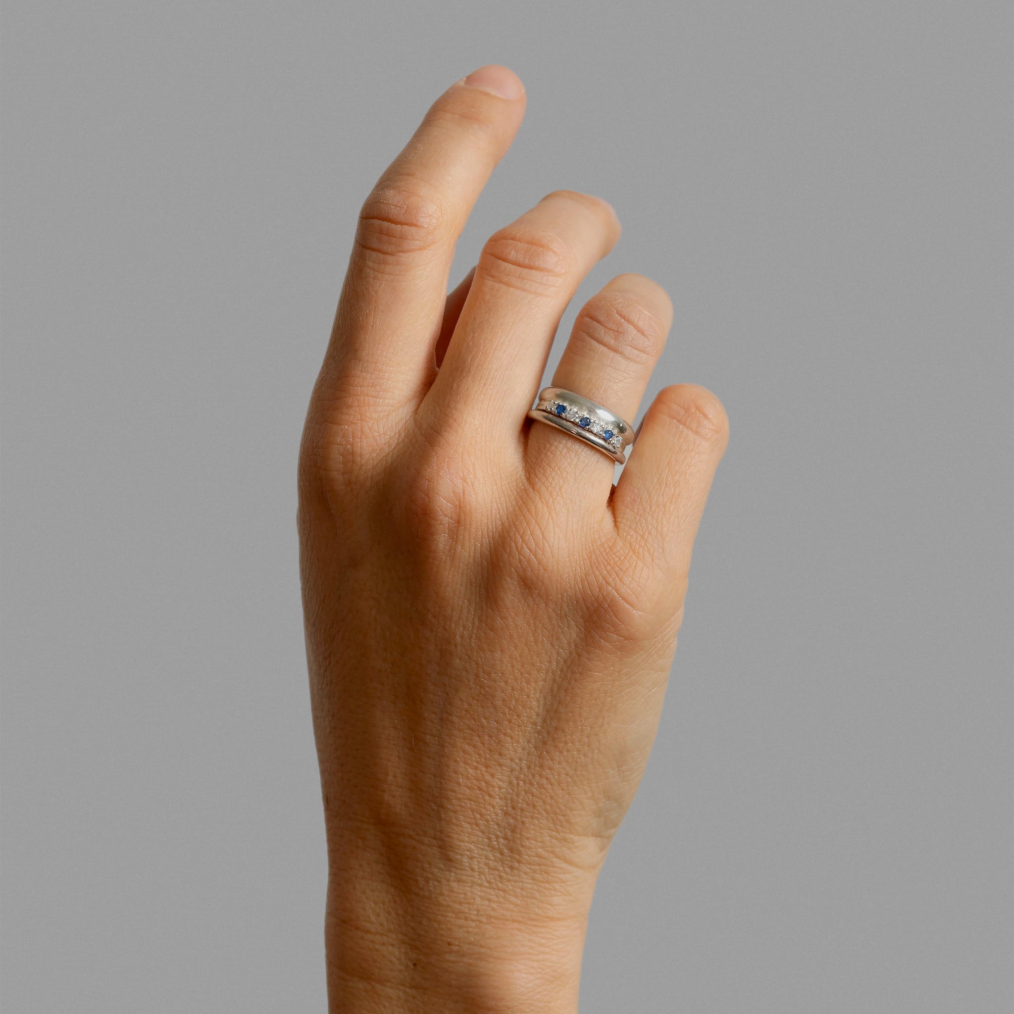 Two silver bands and a half eternity ring