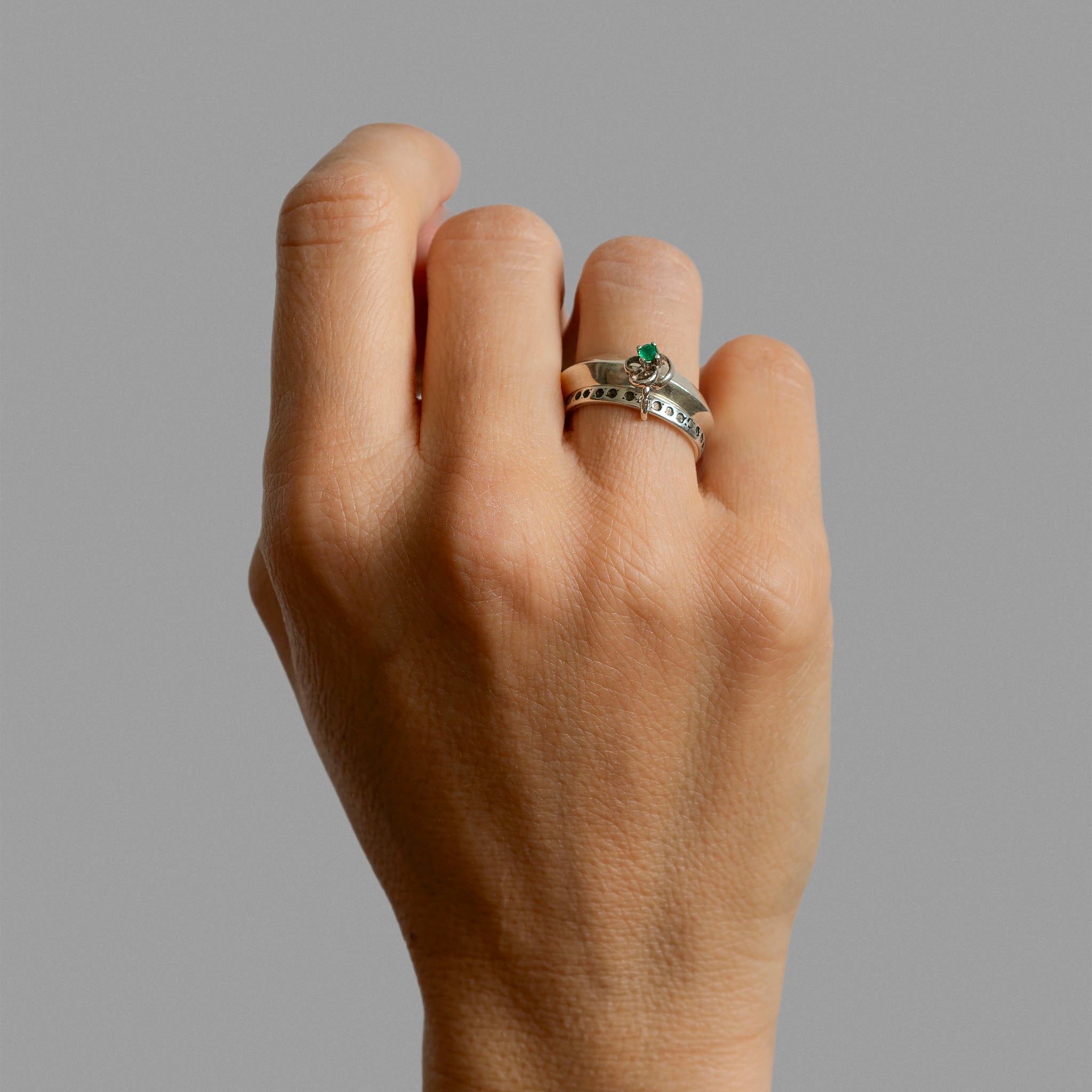 Two found silver rings and a single earring.
