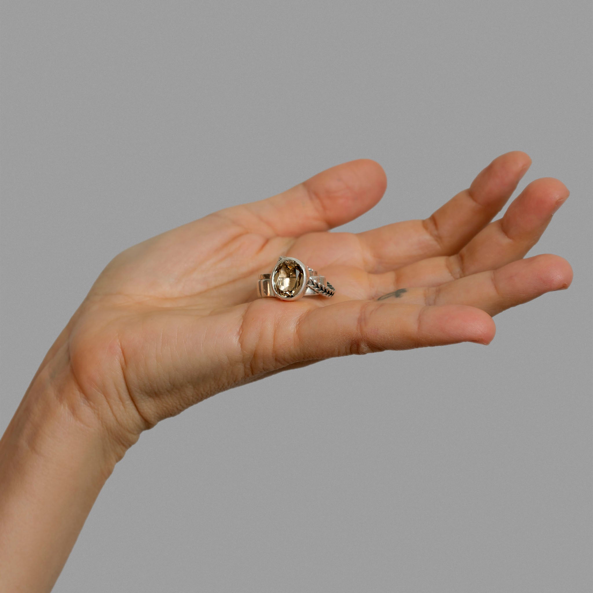 Three found silver rings and a smoky quartz.