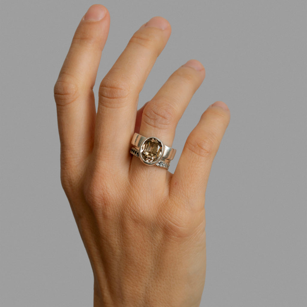 Three found silver rings and a smoky quartz.