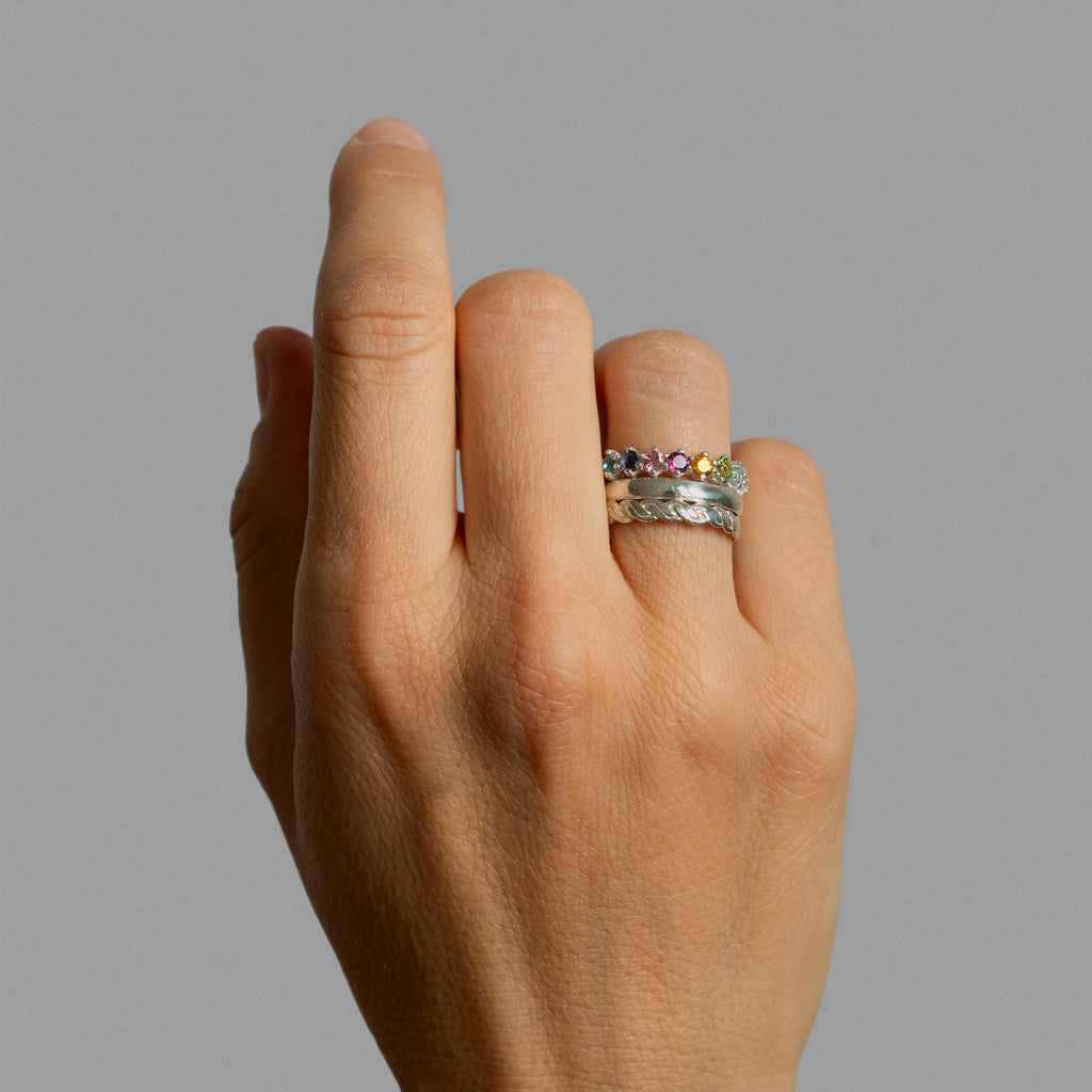 Two silver rings and a half eternity ring.