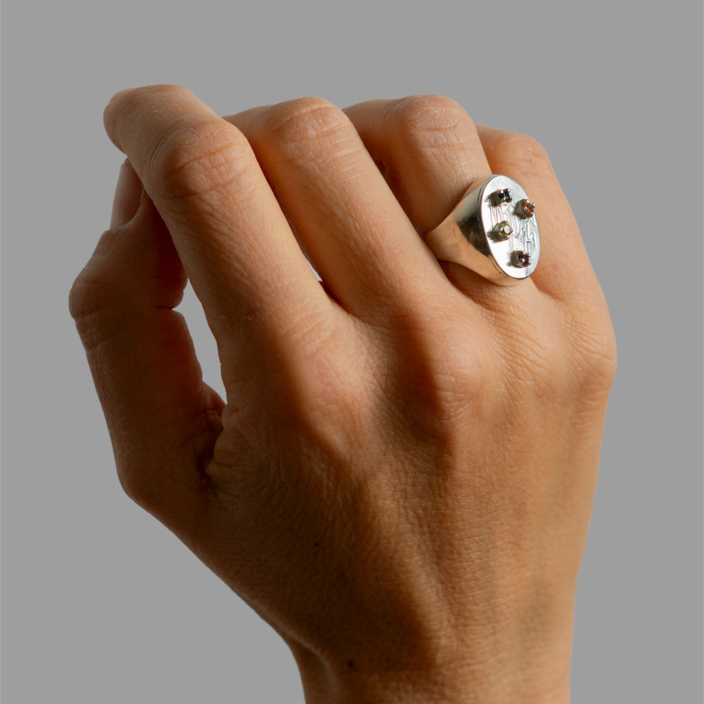 Engraved signet rign with found 4 prong settings.