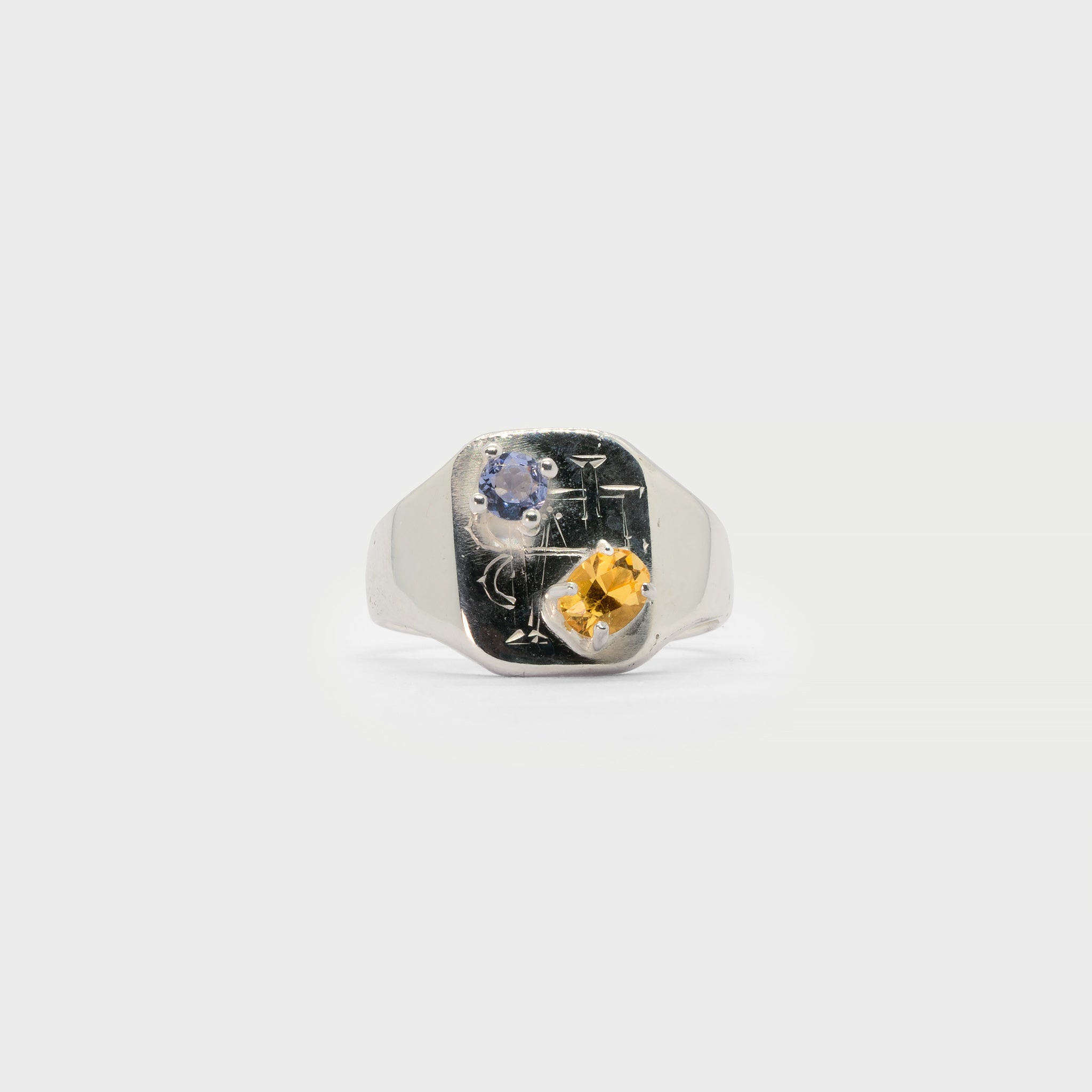 Engraved signet ring with two prong settings.