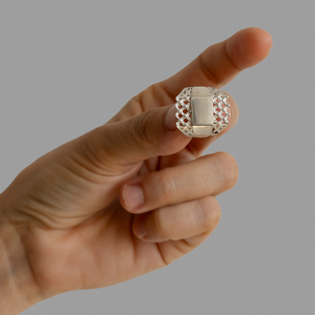 Two halfs of a signet ring and a signet ring.