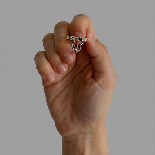 A found silver ring with a silver chain and a garnet.