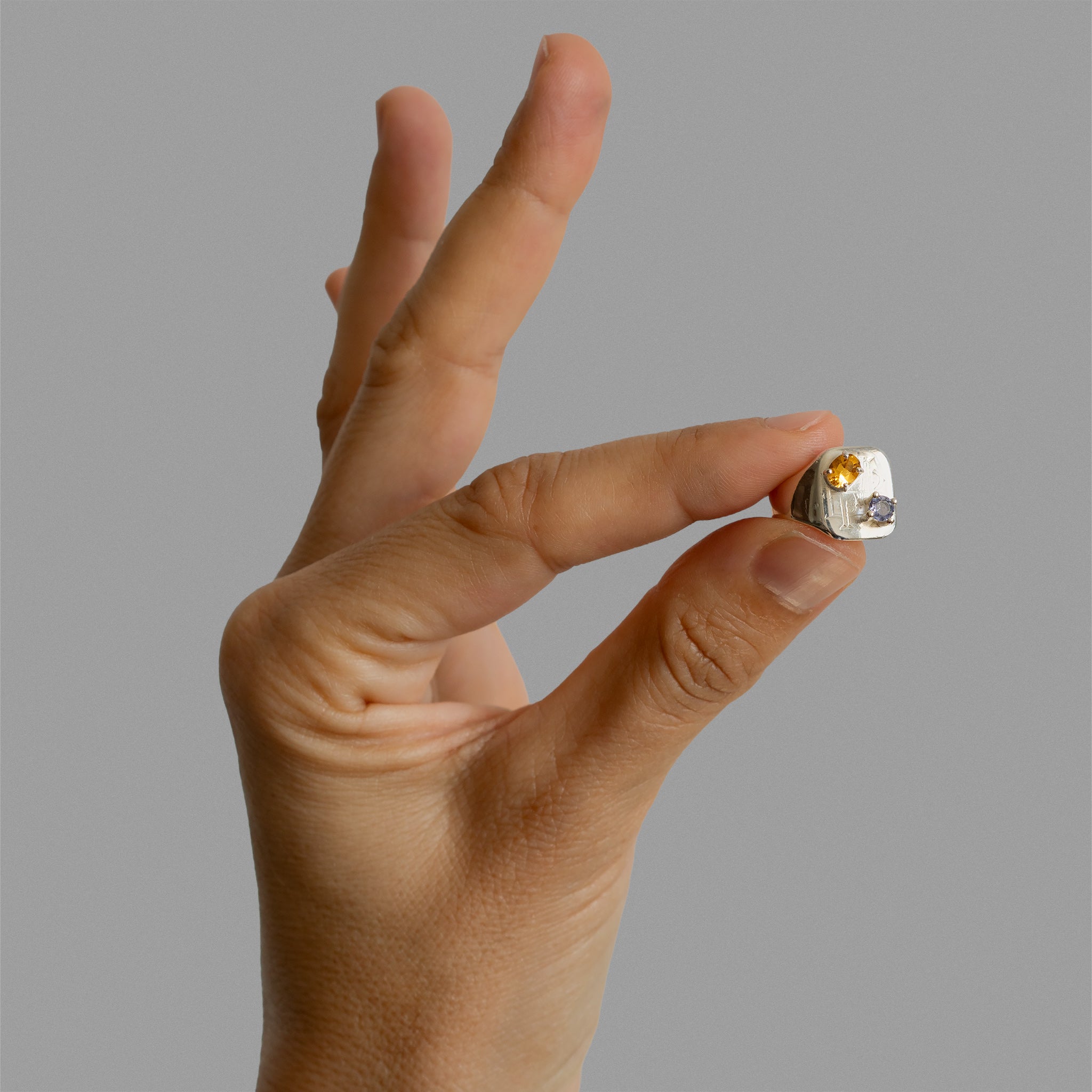 Engraved signet ring with two prong settings.