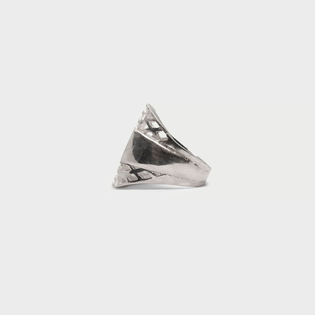 Two halfs of a signet ring and a signet ring.