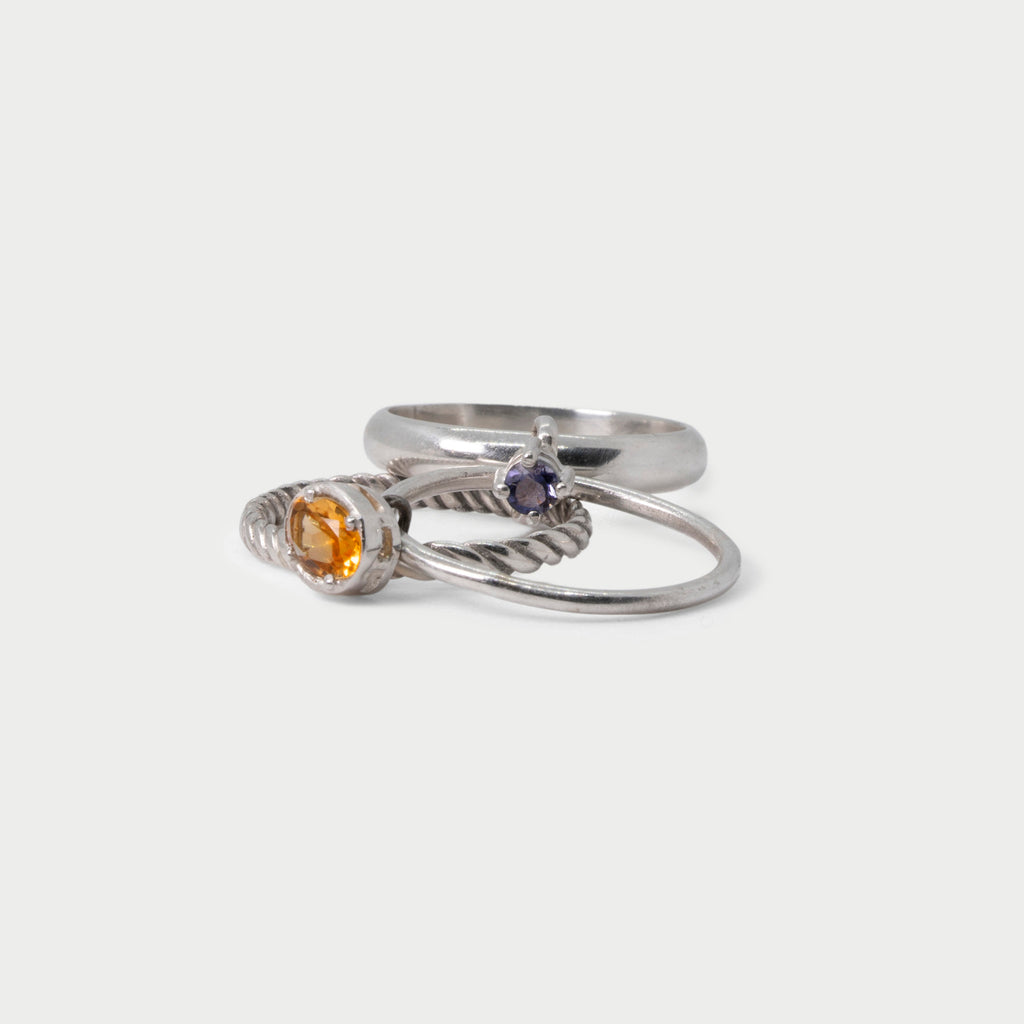 Three  found silver rings joined by bezel-set stones