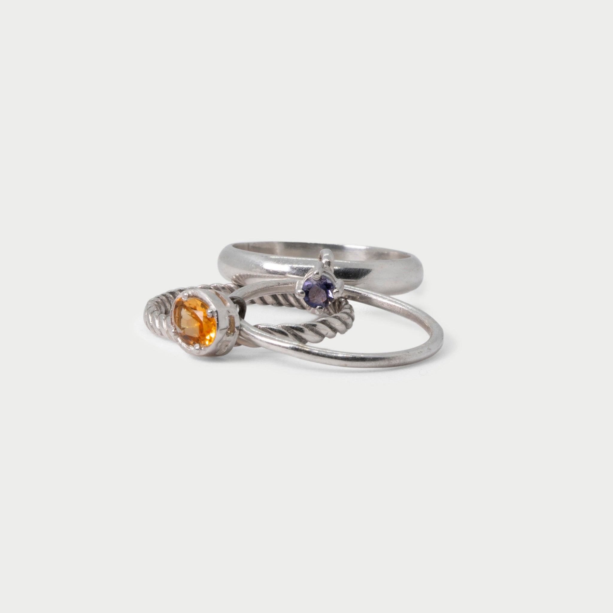 Three  found silver rings joined by bezel-set stones