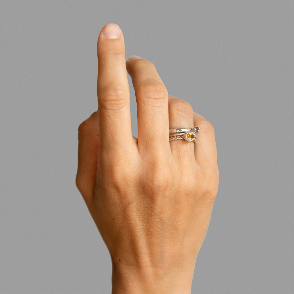 Three  found silver rings joined by bezel-set stones