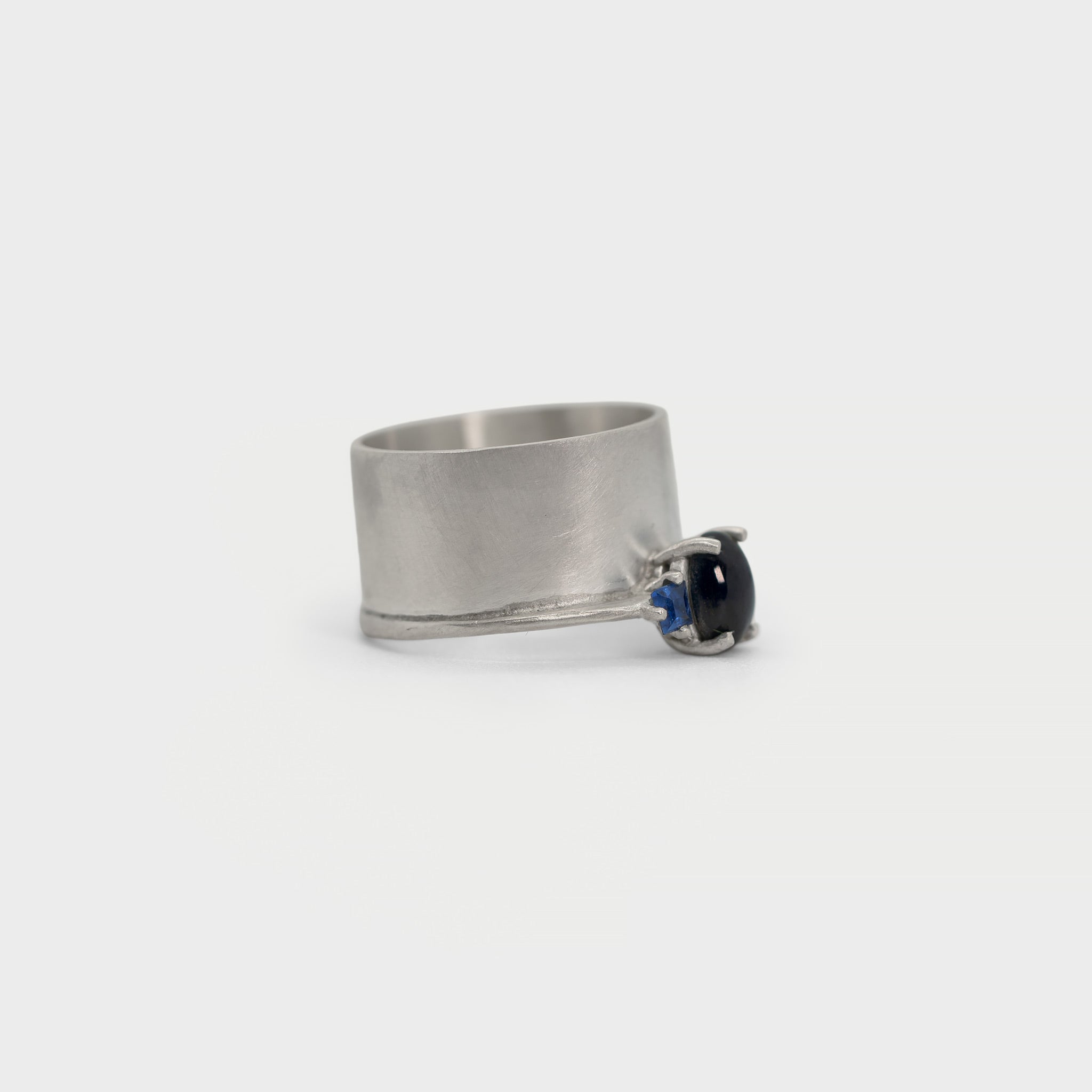 Wide band and solitaire with side sapphires ring