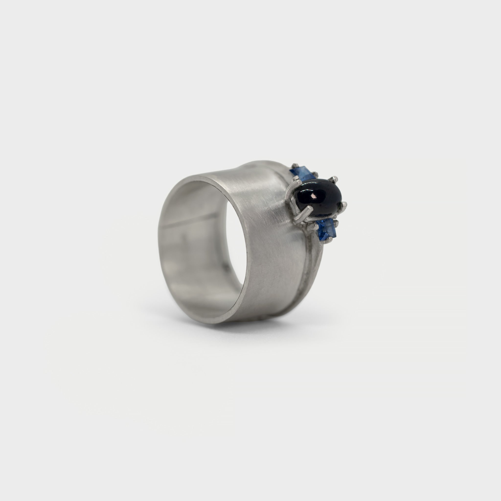 Wide band and solitaire with side sapphires ring