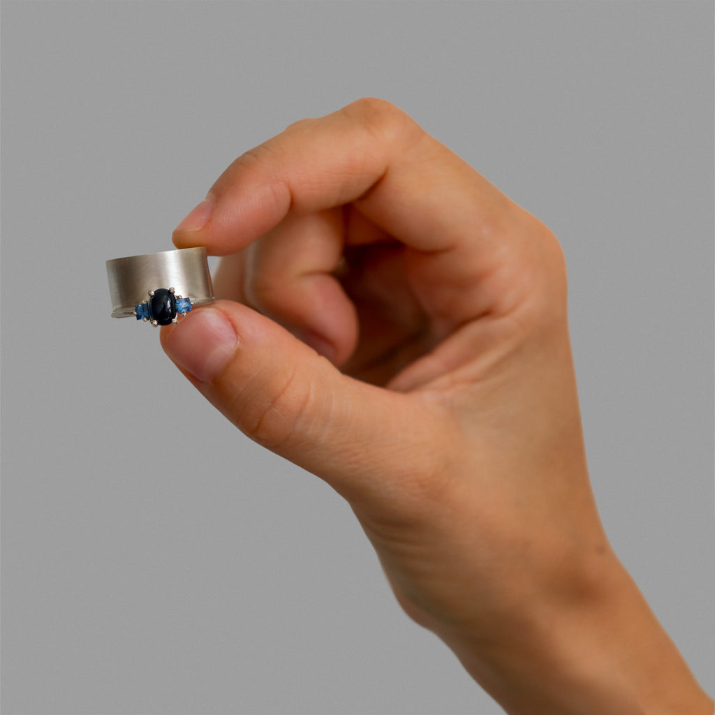 Wide band and solitaire with side sapphires ring