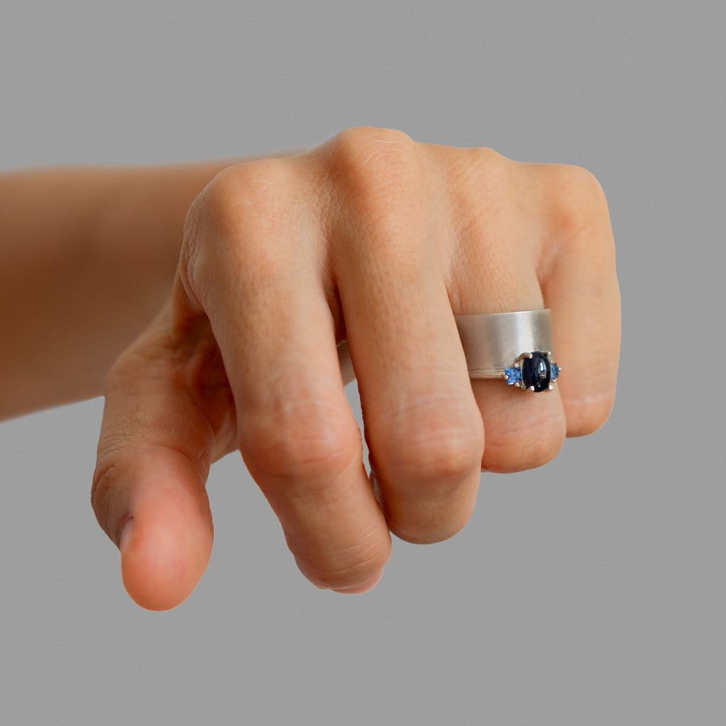 Wide band and solitaire with side sapphires ring
